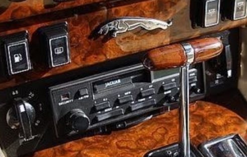 Jaguar radio set into a burl walnut console